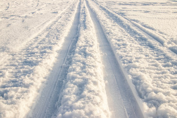 Traces of a snowmobile on the snow.