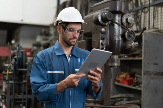 Confident engineers and handsome people are confident and successful in standing jobs in industrial environments.