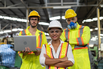 Portrait of factory male and female engineers with confidence and success in uniforms and personal safety protection equipment.