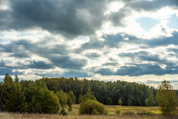 Beautiful clouds in autumn day in the forest near Moscow - nature of Russia.