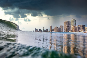 A tsunami like king tide, dark stormy sky and rain aproach the buildings of Surfers paradise, Gold...