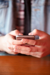 young man holding phone in hand