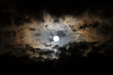Fototapeta na wymiar Full Moon, Snow Moon with billowing clouds