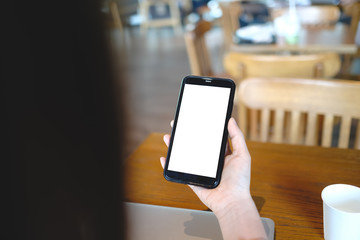 Close up of woman using cell phone,sending massages on the coffee shop.having sunbath.Phone with black screen,texting,video calls,