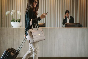 Fotobehang Business traveler in hotel hallway with phone © Jacob Lund