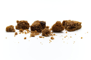 Biscuit with chocolate chip flavored. Some broken and crumbs of crunchy delicious sweet meal and useful cookie with on white background. Selective focus.