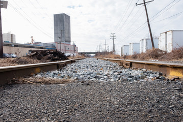 Fototapeta na wymiar Industrial train tracks in urban area. Isolated train tracks in industrial urban area.