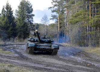 Russian battle tanks on the exercises in the forest area