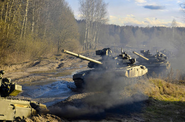 Russian battle tanks on the exercises in the forest area