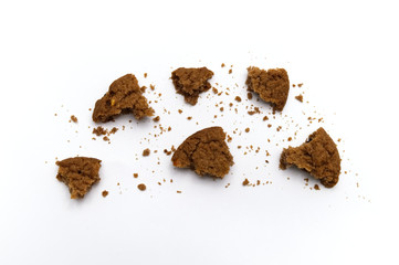 Biscuit with chocolate chip flavored. Some broken and crumbs of crunchy delicious sweet meal and useful cookie with on white background. Top view.