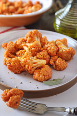 Vegetarian cuisine: spicy roasted cauliflower in tomato sauce and olive oil