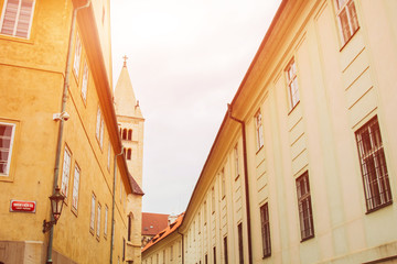 Prague, Czech Republic. 10.05.2019: Detail of the yellow facade of a historic building in the old town of beautiful Prague, Czech Republic. Golden hourly photograph. The sun shines on the facade.