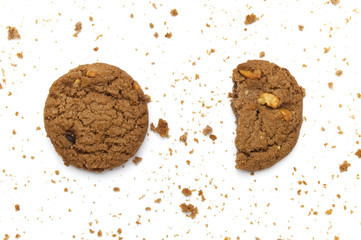 Cookies with chocolate chip flavored. Some broken and crumbs of crunchy delicious sweet meal and useful biscuits on white background.