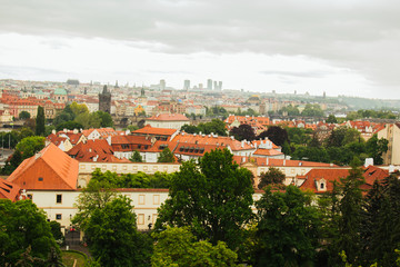 Fototapeta na wymiar Prague. 05.10.2019: Orange colored roof tops of Prague old town buildings and baroque style houses viewed from top of old town hall tower, Prague, Czech Republic. Panorama.