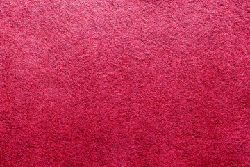 Abstract background with red texture, velvet fabric, close-up. Colorful felt texture for background with copy space. Felt fabric sheet