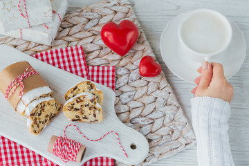 A cup of coffee or cappuccinoand Christmas baking on wooden background