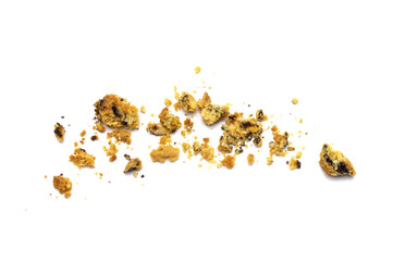 Scattered crumbs of homemade oatmeal raisin cookies isolated on white background.