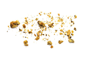 Scattered crumbs of homemade oatmeal raisin cookies isolated on white background.