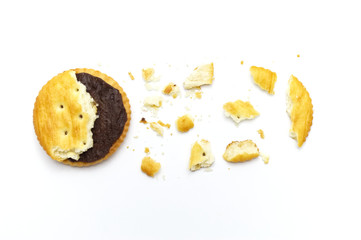 Biscuit some broken or crack and crumbs of sandwich cracker chocolate cream flavoured. Crunchy delicious sweet meal and useful cookies. On white background.