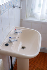 Old style peach coloured bathroom sink