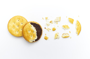 Biscuits some broken or crack and crumbs of sandwich cracker chocolate cream flavoured. Crunchy delicious sweet meal and useful cookies. On white background.