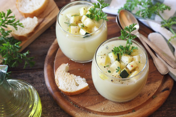 Two verrines of cold Zucchini vegretable cream soup, parsley and olive oil dressing