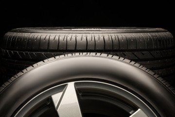 new summer tire on a black background. empty space on the sidewall. concept photo. copyspace