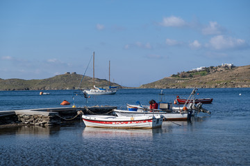 Fototapeta na wymiar Boats and yachts are moored at a stone quay at Vourkari Tzia, Kea island, Greece.