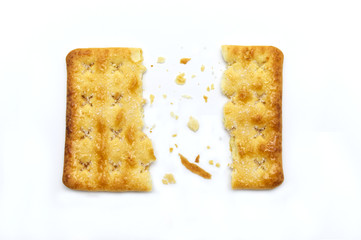 Broken square crackers biscuits isolated on white background. Crushed dry snack.