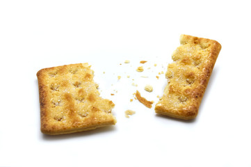 Broken square crackers biscuits isolated on white background. Crushed dry snack.
