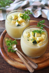 Two verrines of cold Zucchini vegretable cream soup, parsley and olive oil dressing