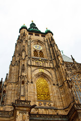 Obraz premium Prague. 05.10.2019: Perspective view of the Metropolitan Cathedral of Saints Vitus, Wenceslaus and Adalbert, an excellent example of Gothic architecture. Golden Gate South Tower with clock.