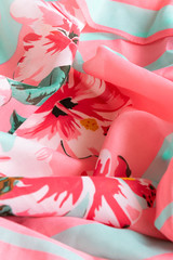 Fresh colorful folded cloth. Crop view of fashioned botanical fabric, pink and blue pastel colors