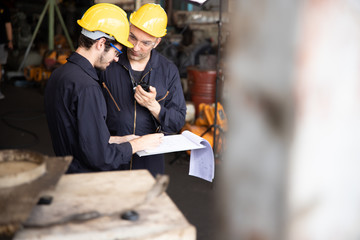 Group of industrial factory maintenance engineers inspect relay protection system using walkie...