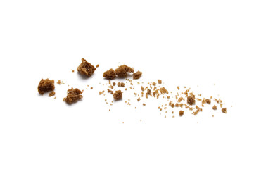 Scattered crumbs of chocolate chip butter cookies on white background.