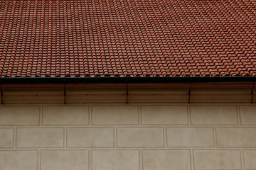 Prague. 05.10.2019: Low light detail of patina red roof top. Prague Lesser Town typical roofing material. Old roofing of clay tiles. Various orange shades and stains.