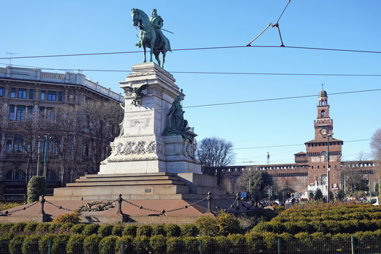 Italy , Milan  February 2020 - Cairoli square in downtown of the city - the famous statue of Giuseppe Garibaldi on a horse and sforza Castle ( Castello Sforzesco ) behinds 