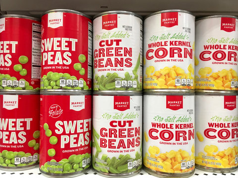 Alameda, CA - October 05, 2017: Grocery store shelf with cans of Market Pantry vegetables, sweet peas, green beans and whole kernel corn.