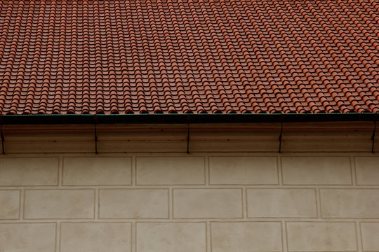 Prague. 05.10.2019: Low light detail of patina red roof top. Prague Lesser Town typical roofing material. Old roofing of clay tiles. Various orange shades and stains.