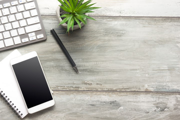White desk office with laptop, smartphone and other work supplies with cup of coffee. Top view with...