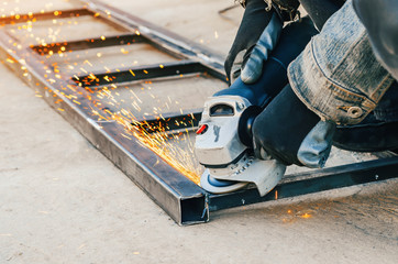 Obraz premium Metal cutting with an electric circular saw. Sparks fly