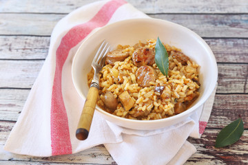 Regional Italian cuisine. Piedmontese risotto with porcini mushrooms and sausages