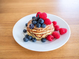 pencakes with peanut butter and fresh blueberries and raspberries