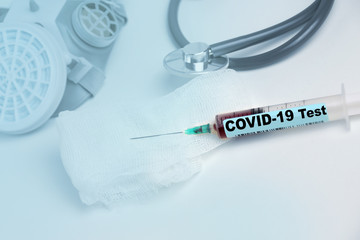 medical laboratory test tube with the word coronavirus test and syringe with blood inside,...