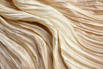 Texture of ivory silk fabric. Background, pattern.