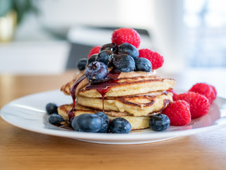 pencakes with peanut butter and fresh blueberries and raspberries