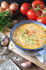 Italian cuisine. Stracciatella tomato soup: parsley, eggs and parmesan cheese