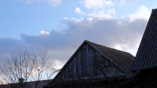 Fast moving clouds in real time over an old wooden barn.