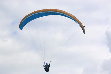 Paraglider flying wing in a blue sky	