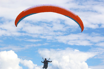 Paraglider flying wing in a blue sky	